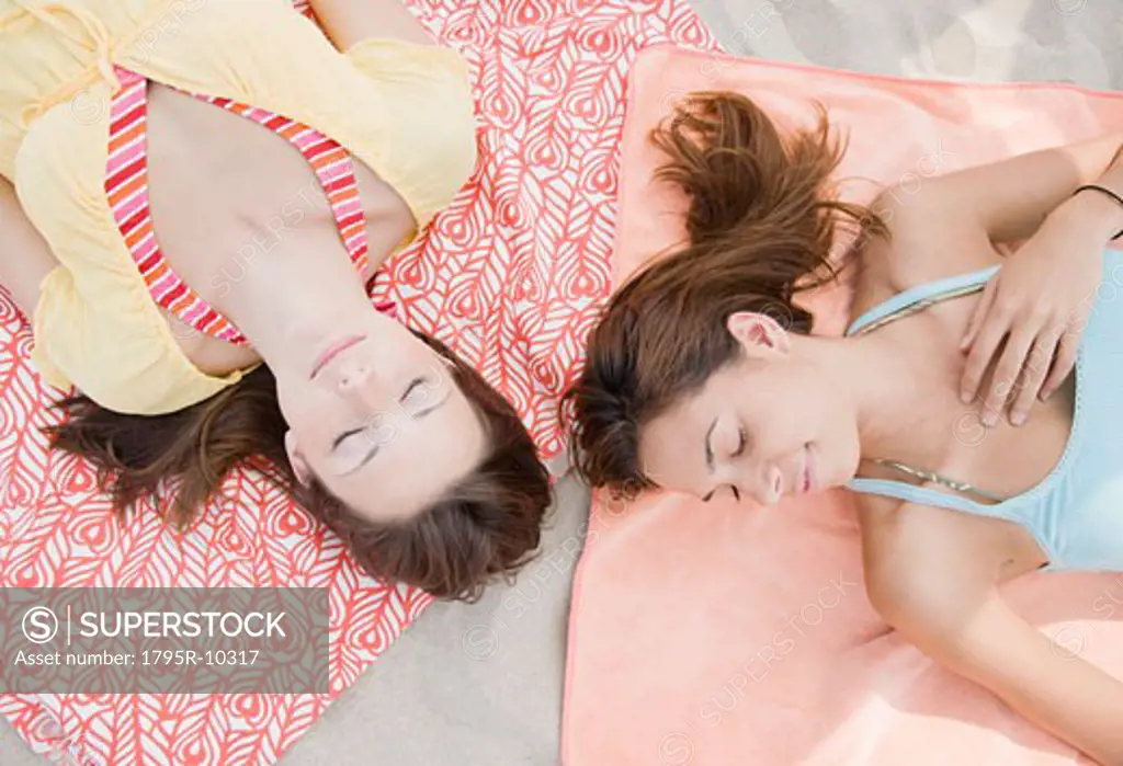Women laying on beach blankets
