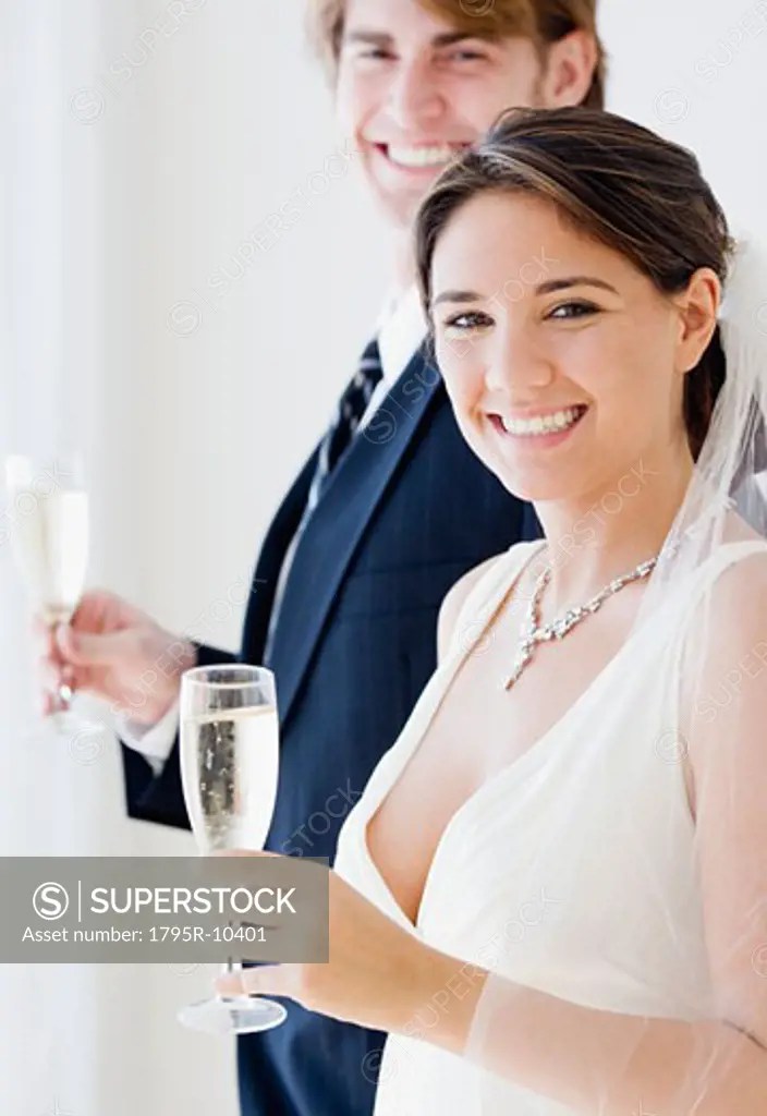 Bride and groom holding champagne glasses