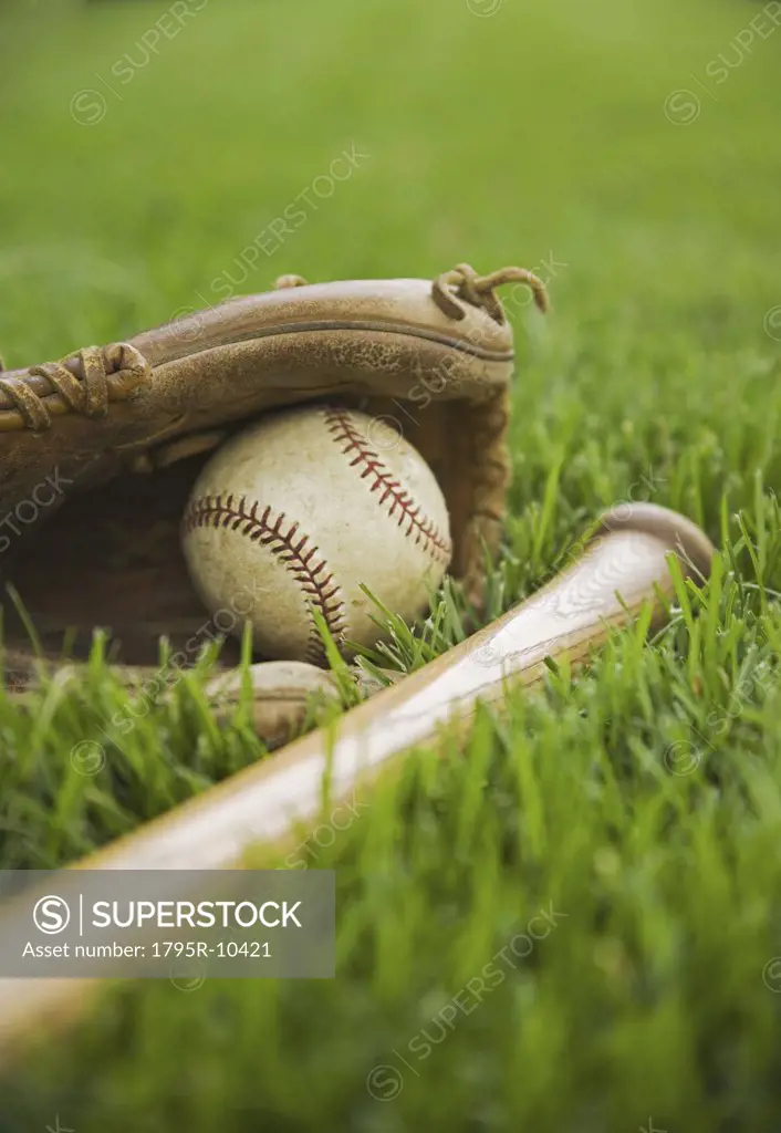 Baseball equipment laying on grass