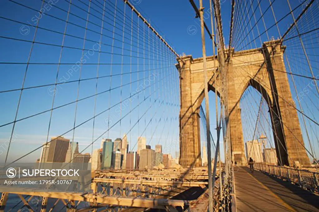 View of skyline through Brooklyn Bridge, New York City
