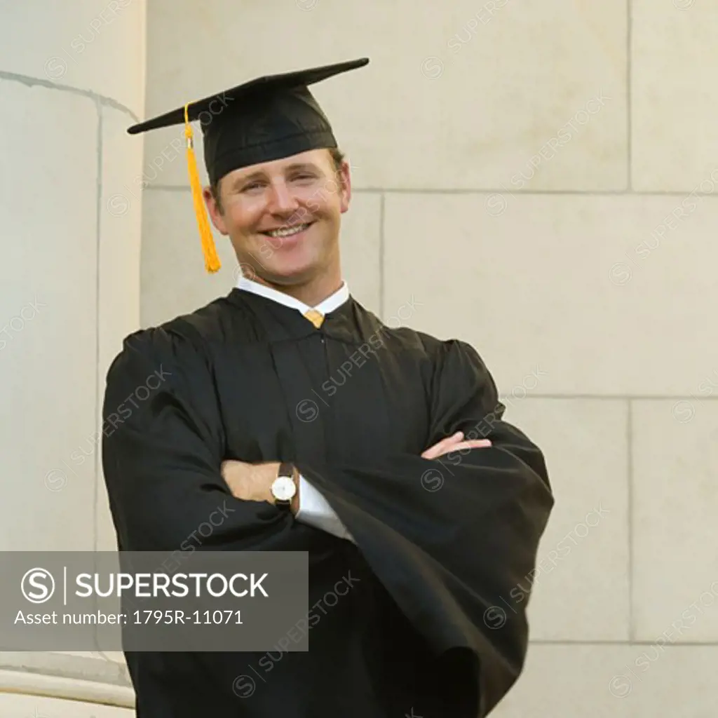Male graduate with arms crossed
