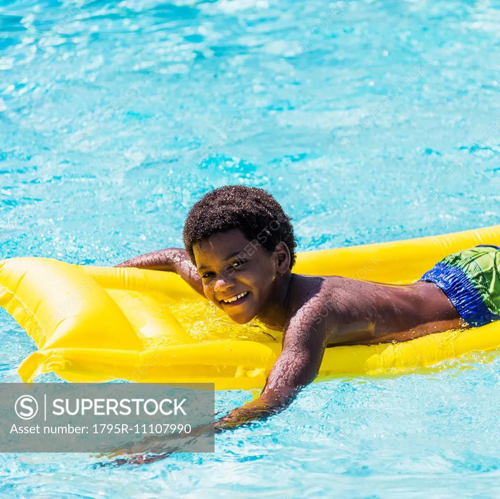 Portrait of boy ( 6-7) with pool raft