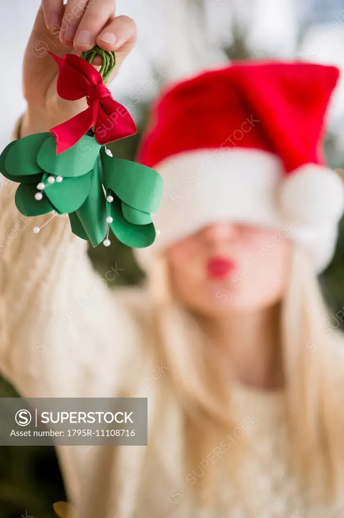 Woman colding christmas decoration