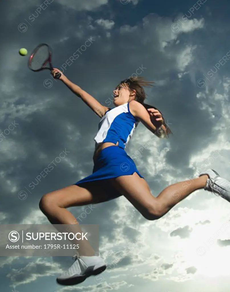 Low angle view of tennis player jumping