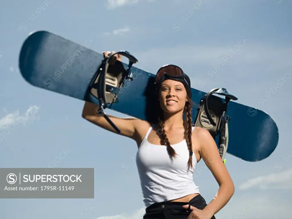 Snowboarder holding board on shoulder