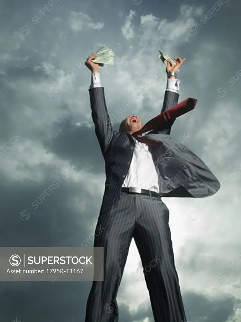 Low angle view of businessman cheering