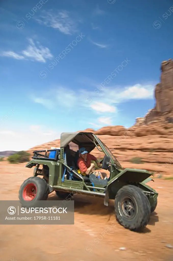 Man driving off-road vehicle in desert