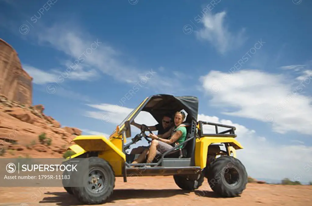 Woman driving off-road vehicle in desert