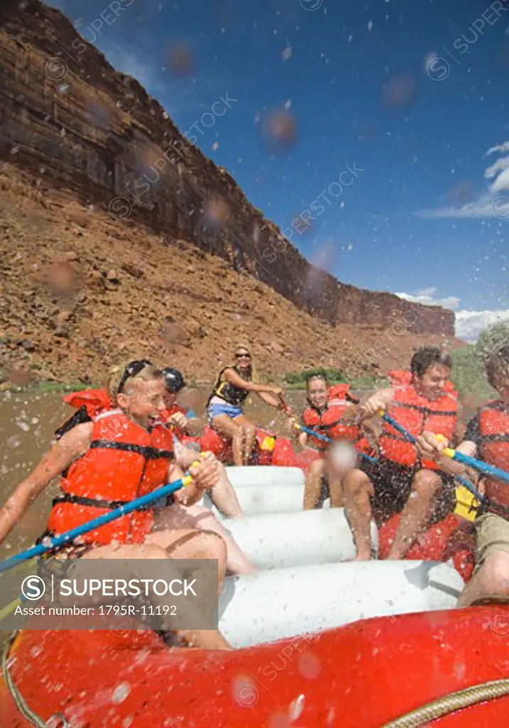 People paddling in raft