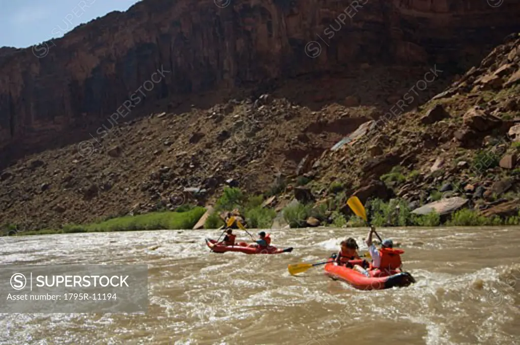 People paddling in rafts
