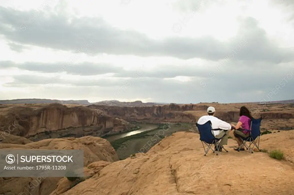 Couple in camping chairs over-looking canyon
