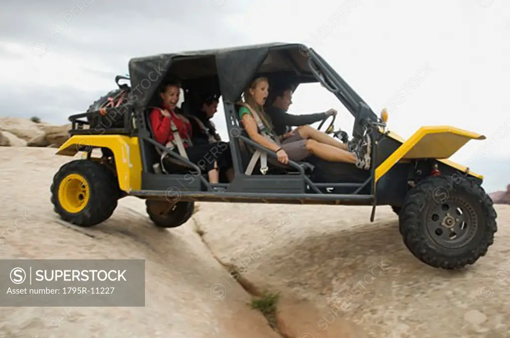 People in off-road vehicle on rock formation