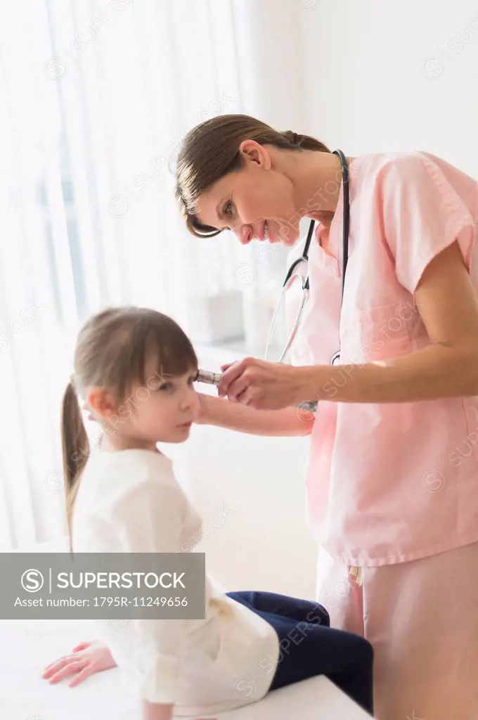 Doctor examining girl (4-5)