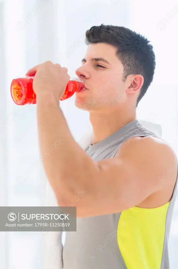 Young man drinking sports drink