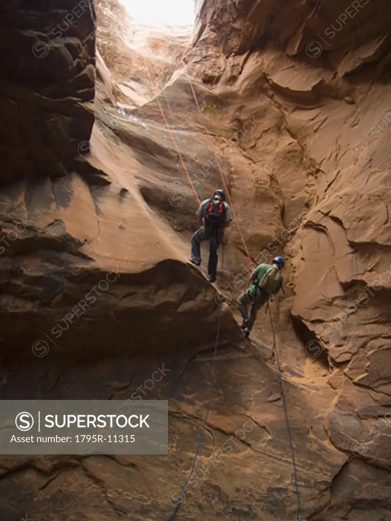 People canyon rappelling
