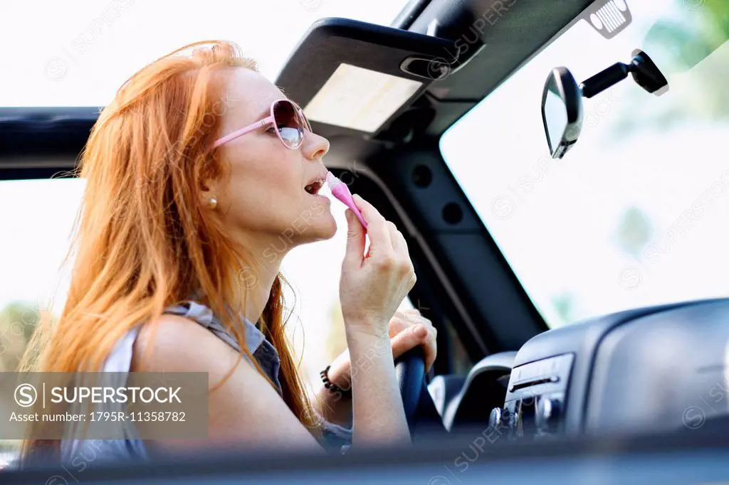 Woman doing make up in car
