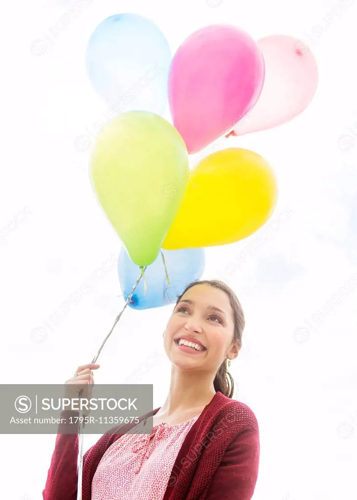 Young woman with colorful balloons