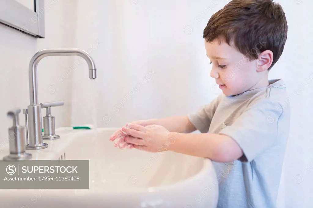 boy (6-7) washing hands