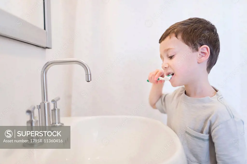 boy (6-7) brushing teeth