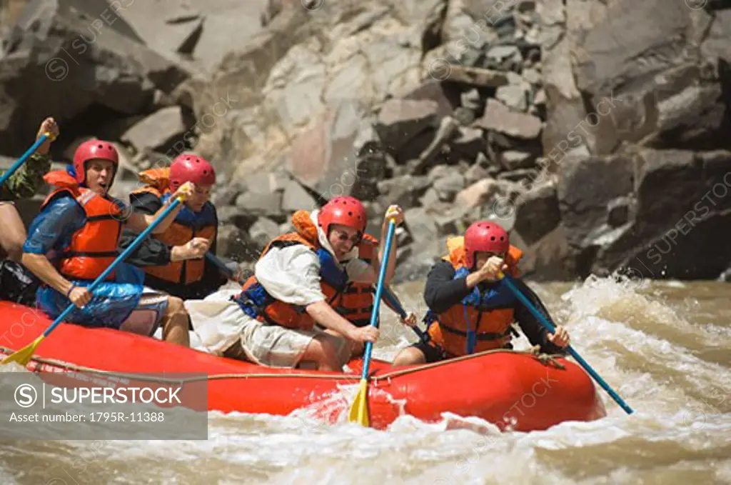 Group of people river rafting