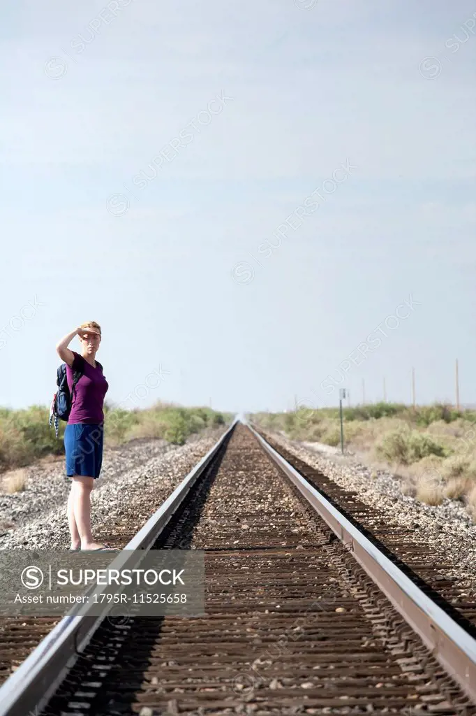 Woman standing by railroad track
