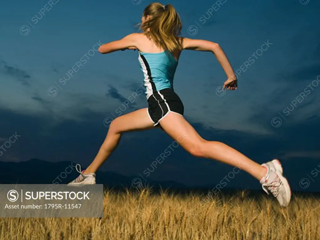 Woman in athletic gear jumping