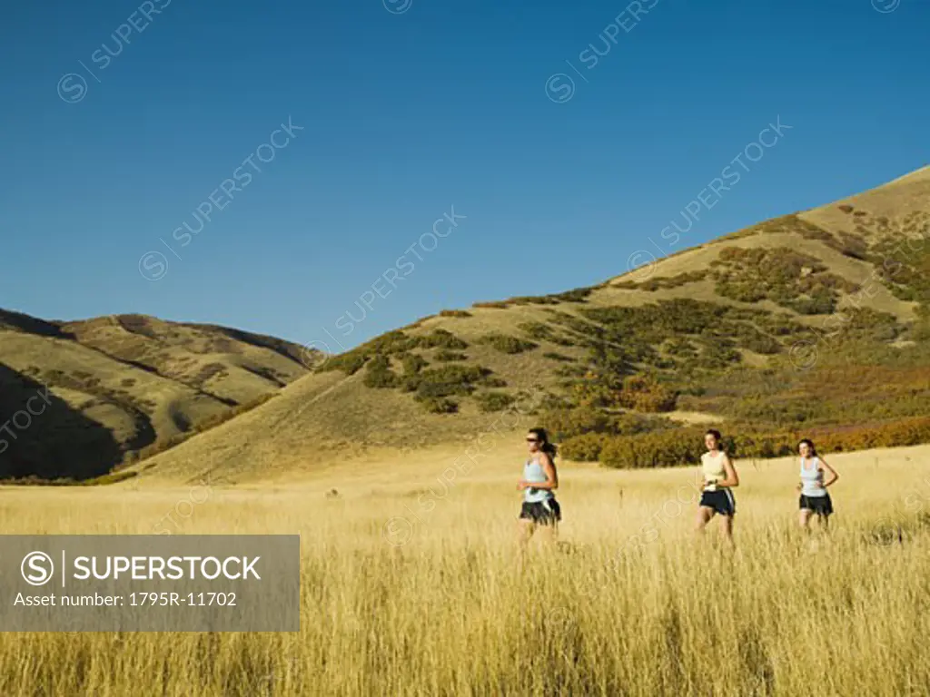 Group of people running in field, Utah, United States