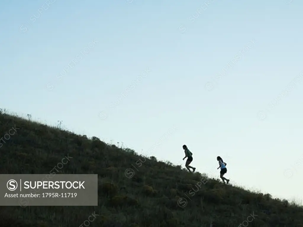 People running up mountain, Salt Flats, Utah, United States