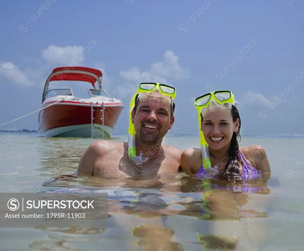 Couple with snorkeling gear in water, Florida, United States