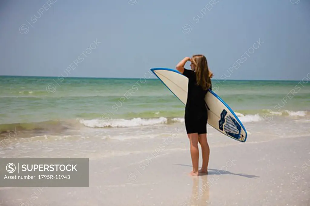 Girl holding surfboard, Florida, United States
