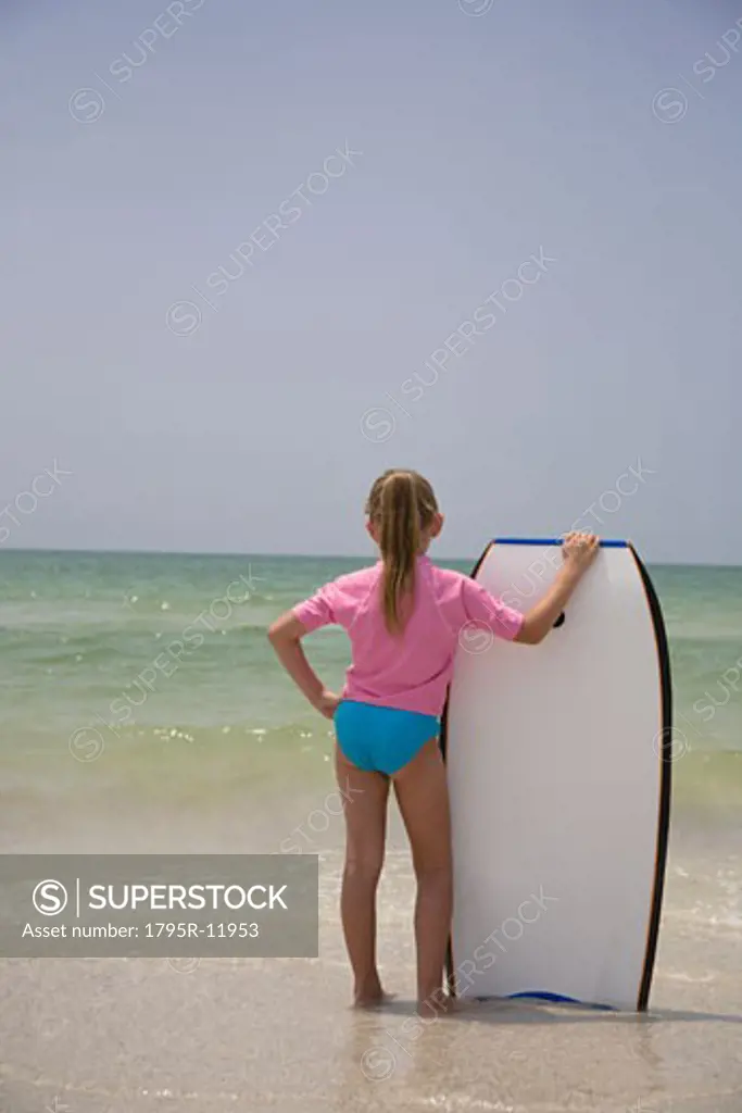 Young girl holding boogie board, Florida, United States