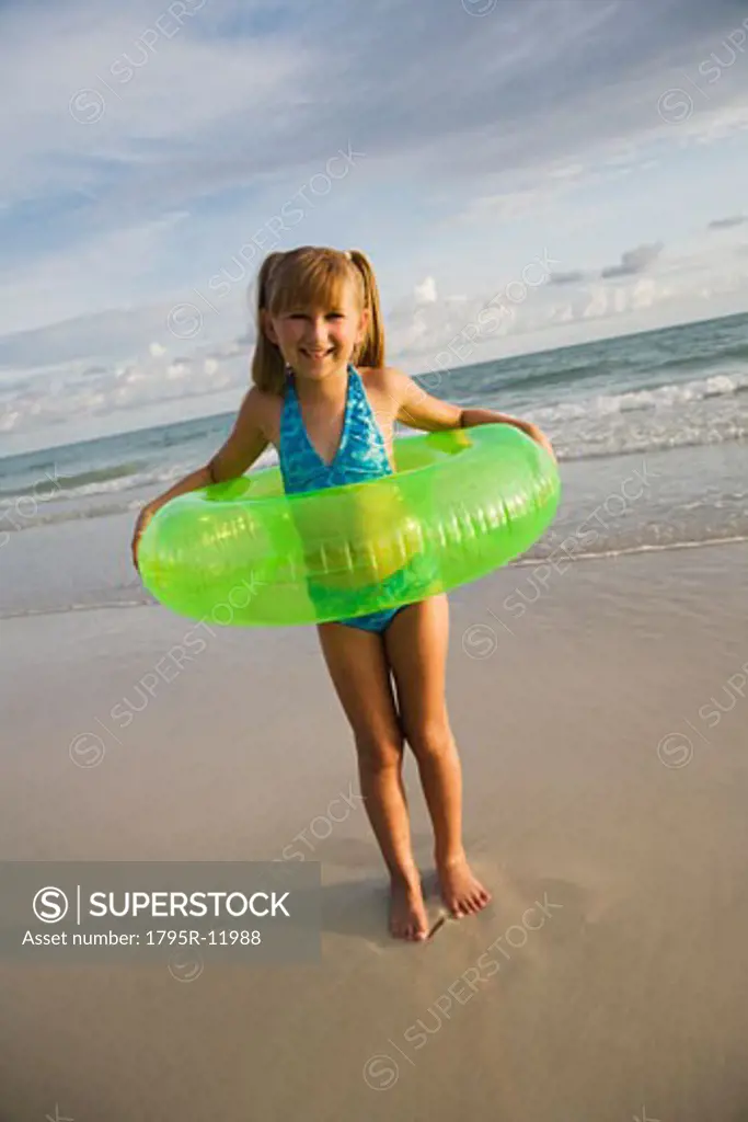Girl in inner tube at beach, Florida, United States