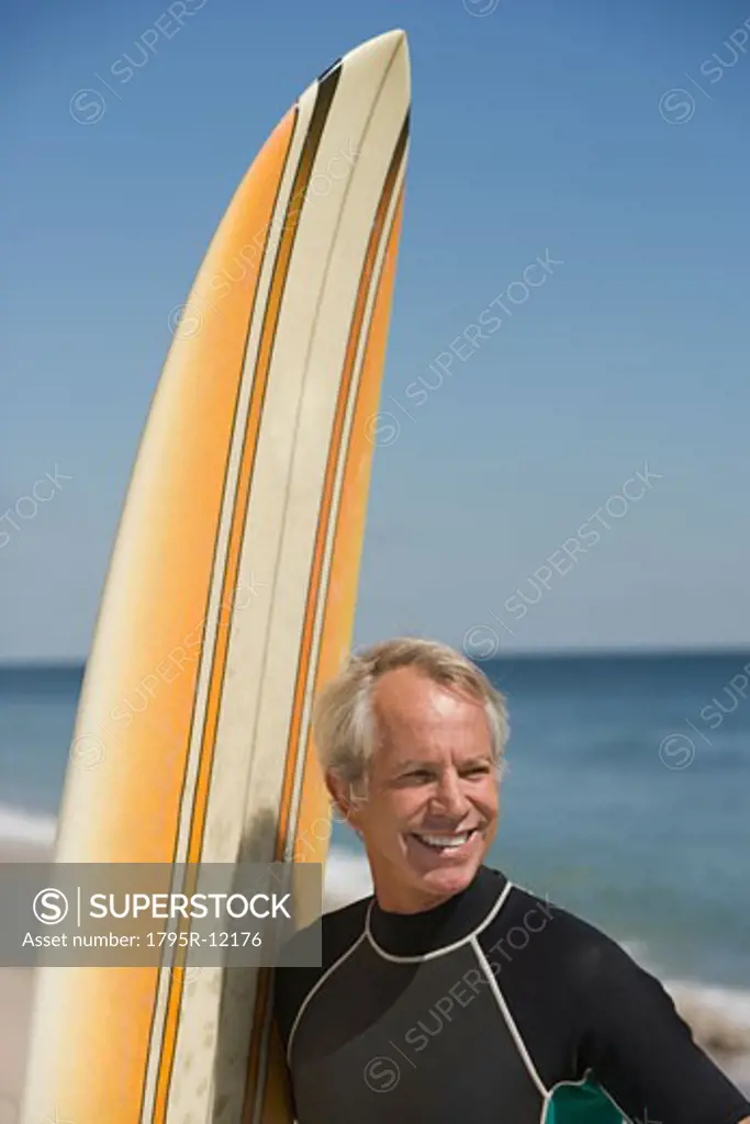 Man next to surfboard at beach