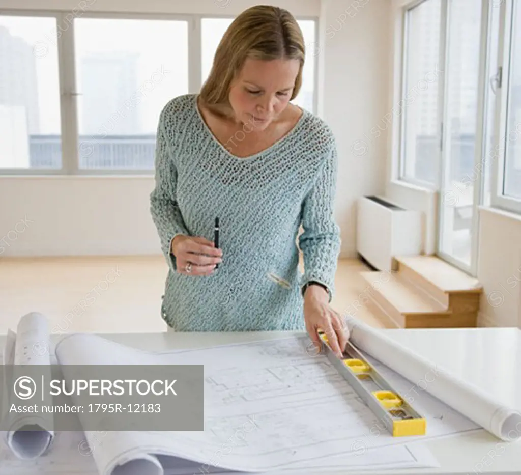 Woman looking at blueprints
