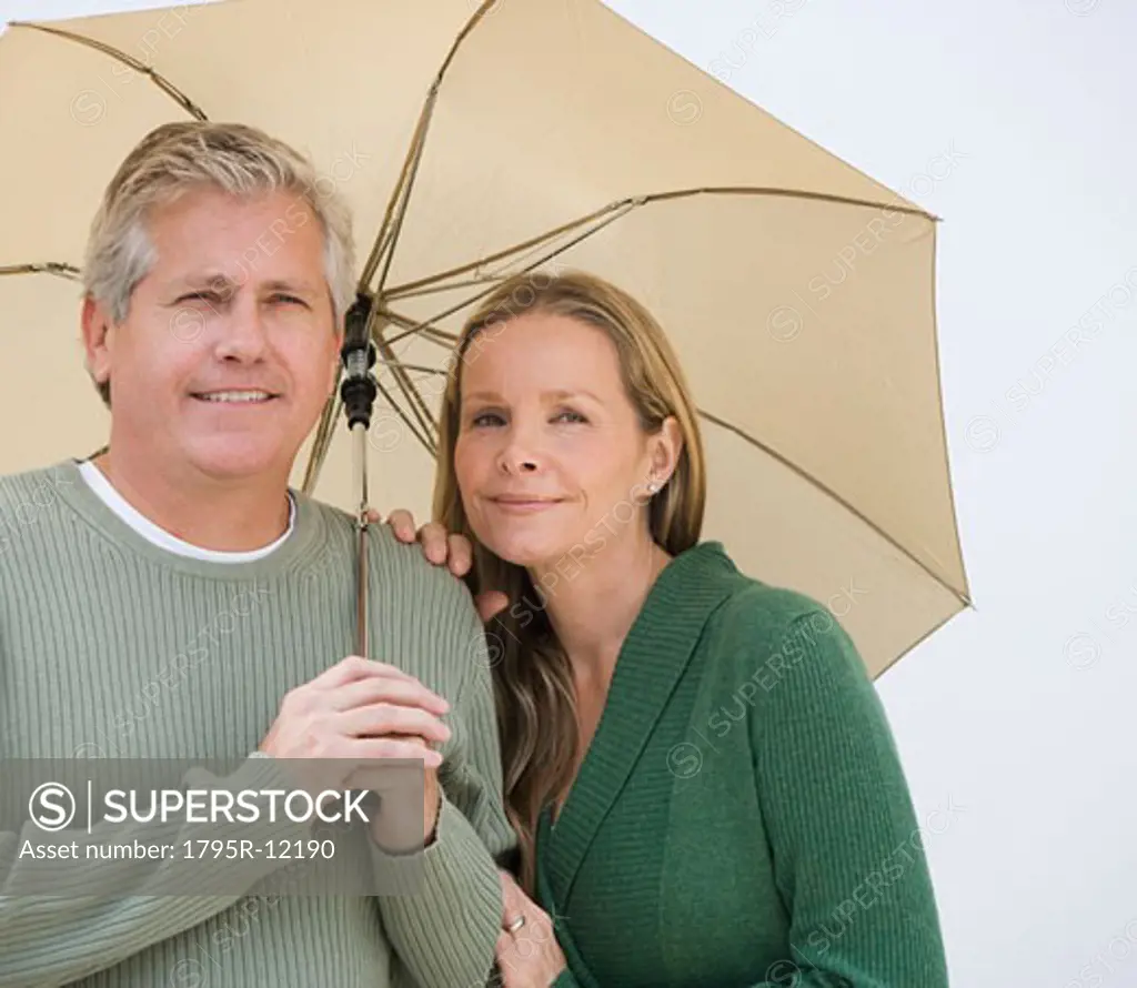 Couple standing under umbrella