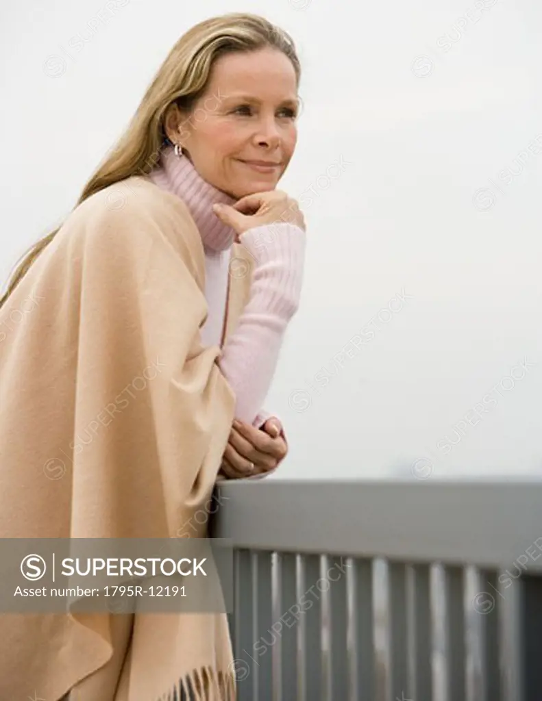 Woman leaning on railing