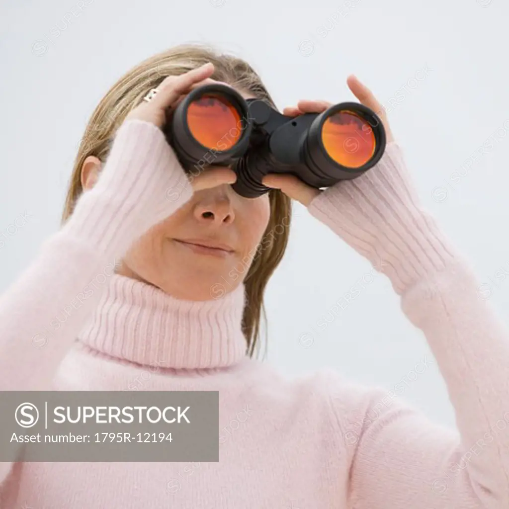 Woman looking through binoculars