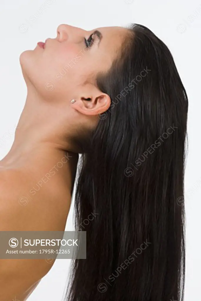 Woman with long hair tilting head back