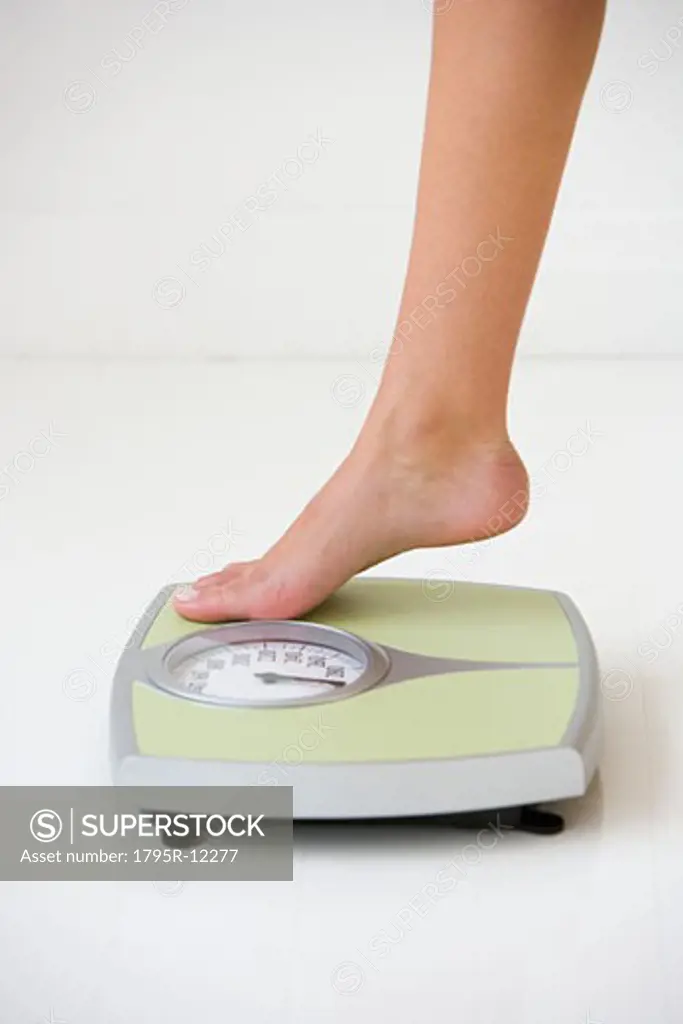 Woman stepping on scale