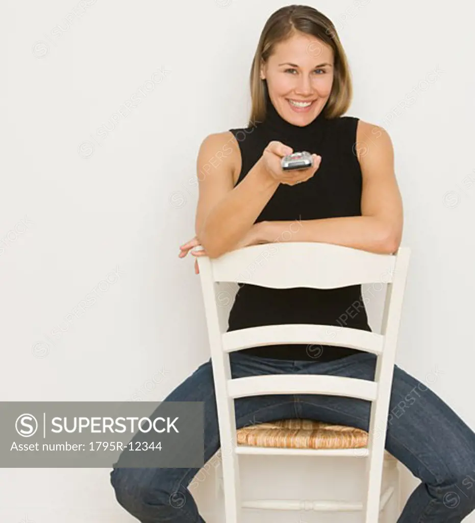 Woman pointing remote control
