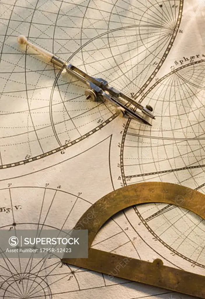 Protractor and drafting compass on antique map