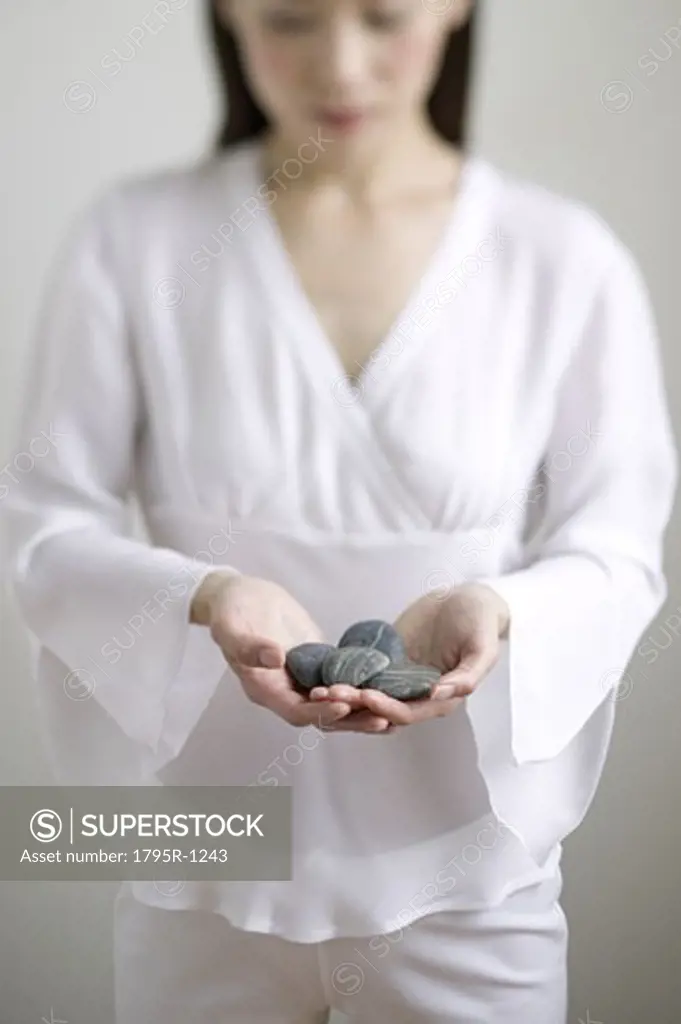 Young woman holding stones