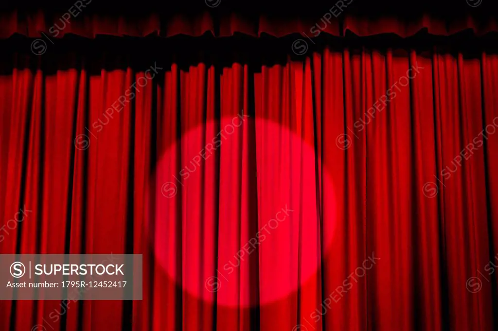 Spotlight on red curtain