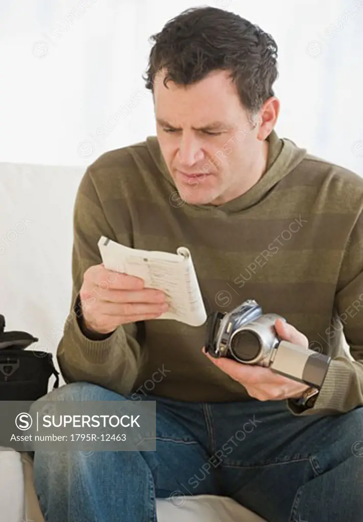 Man reading camera manual