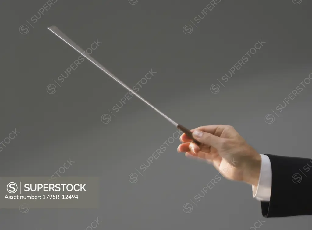 Male conductor's hand holding baton