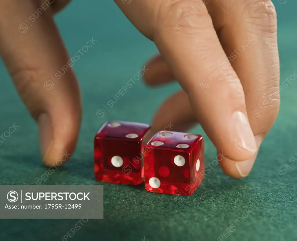 Close-up of man reaching for dice
