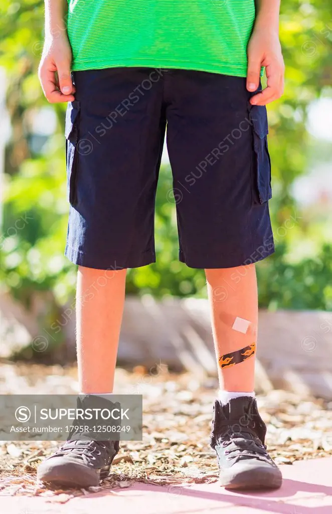 Low-section of boy (8-9) with bandages on legs