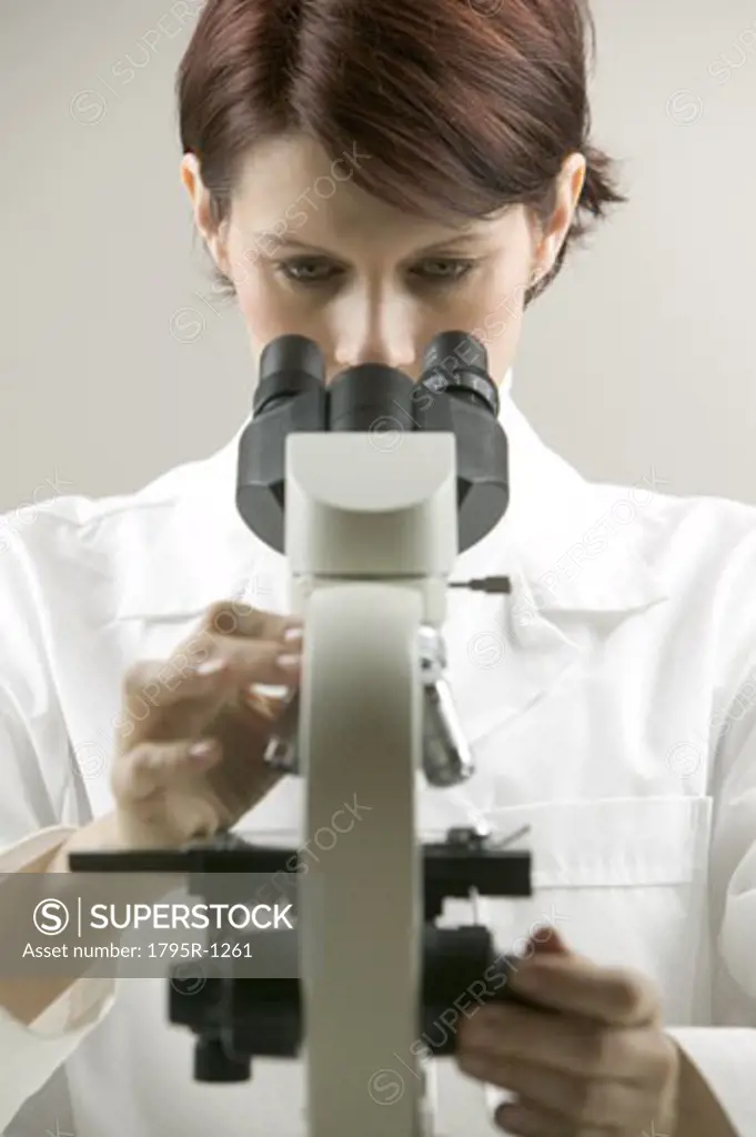 Lab technician at a microscope