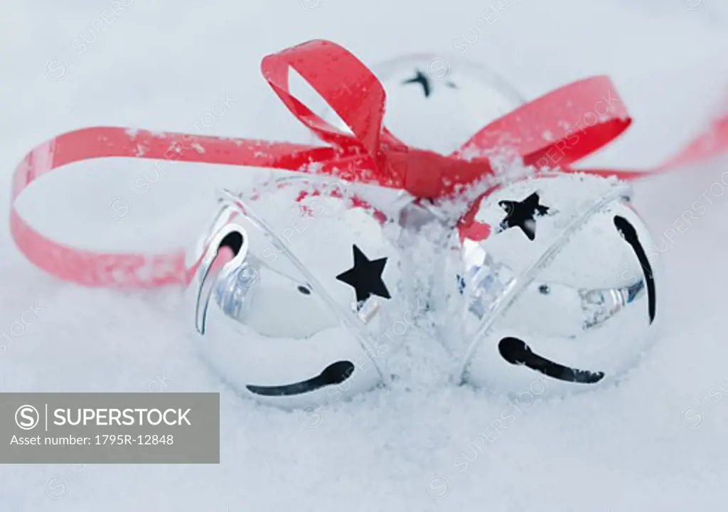Close-up of jingle bells in snow