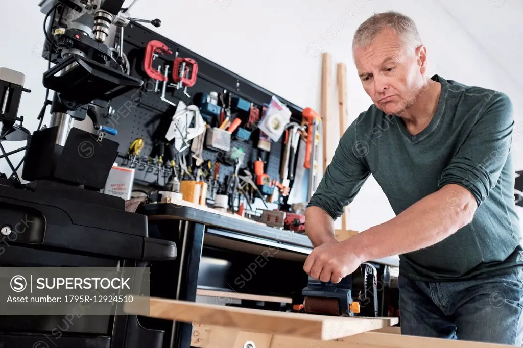 Man working with wood in home workshop